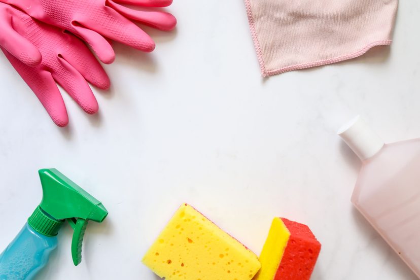 Cleaning supplies laid out on a white surface